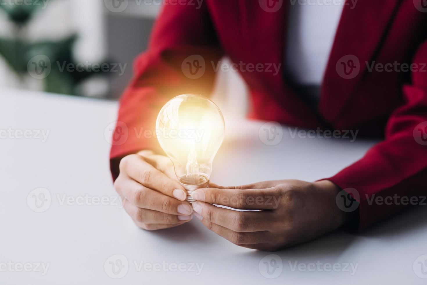 Business People touch Light bulb.Concept of Ideas for Success. Concept with Innovation Invention. Success Starting from a new idea to innovative technology based on data from the Internet, big data. photo