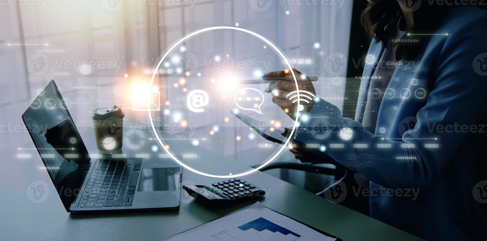 Contact us or Customer support hotline people connect. Businessman using a laptop and touching on virtual screen contact icons email, address, live chat, internet wifi photo