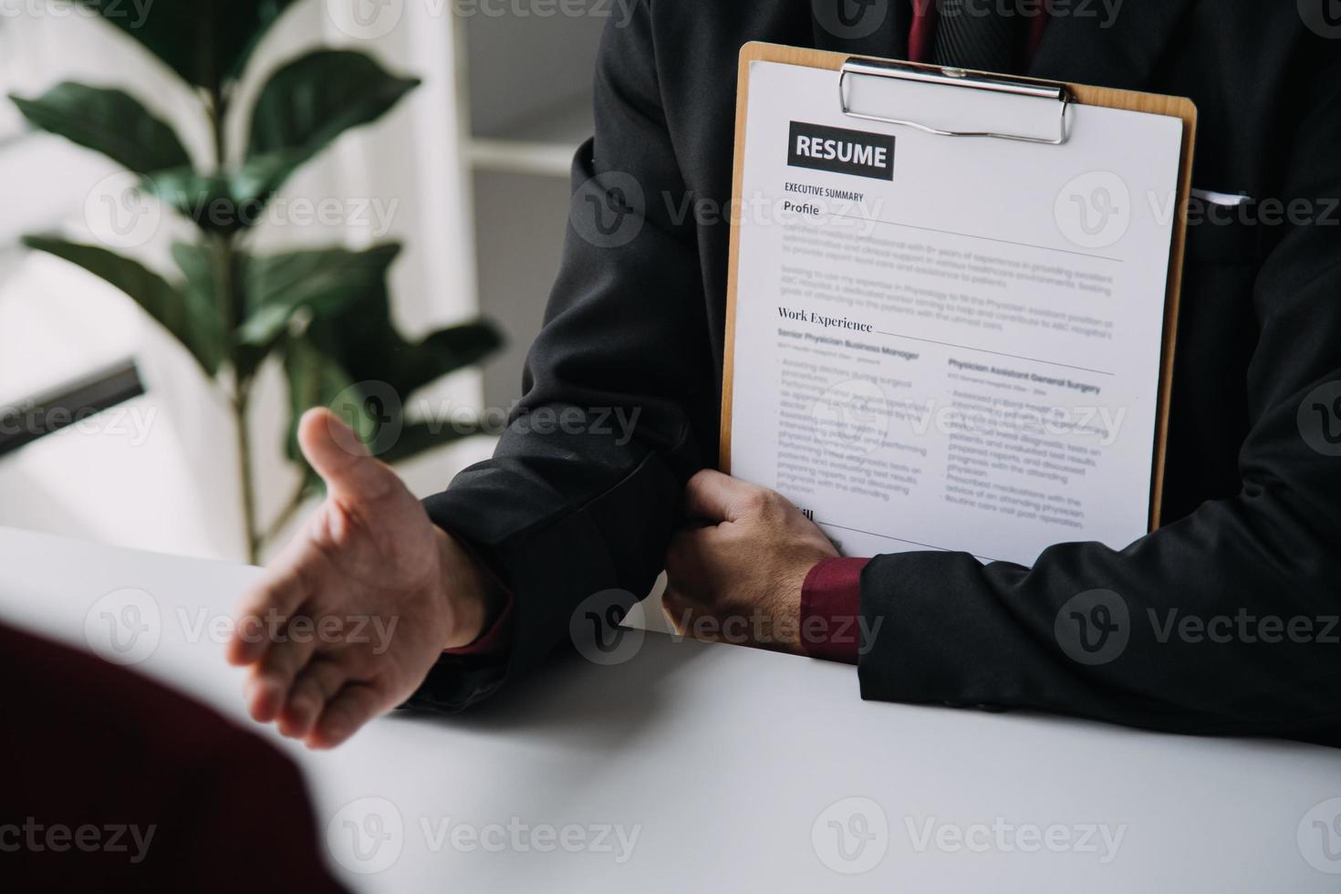 Close up view of job interview in office, focus on resume writing tips, employer reviewing good cv of prepared skilled applicant, recruiter considering application, hr manager making hiring decision photo