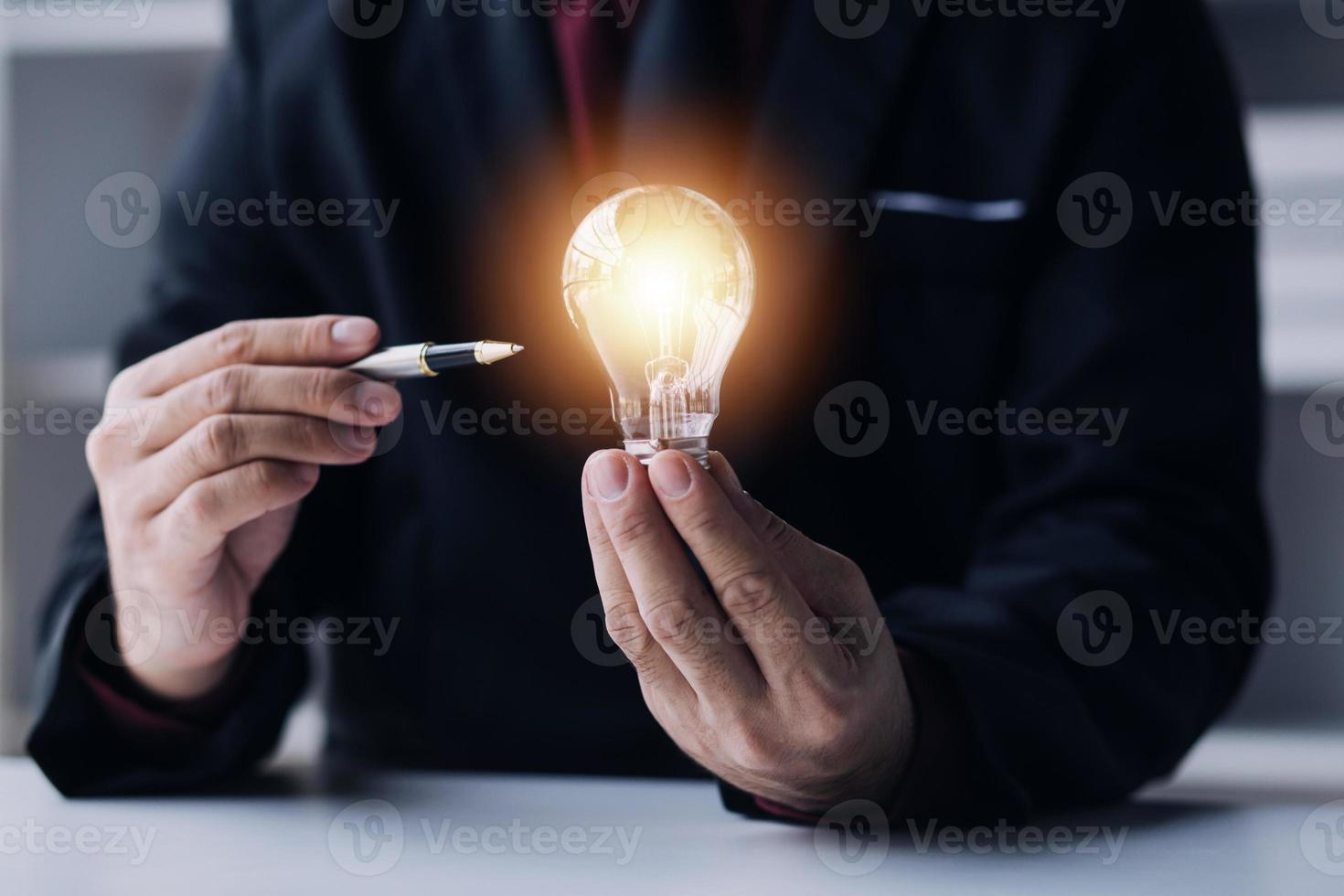 Business People touch Light bulb.Concept of Ideas for Success. Concept with Innovation Invention. Success Starting from a new idea to innovative technology based on data from the Internet, big data. photo