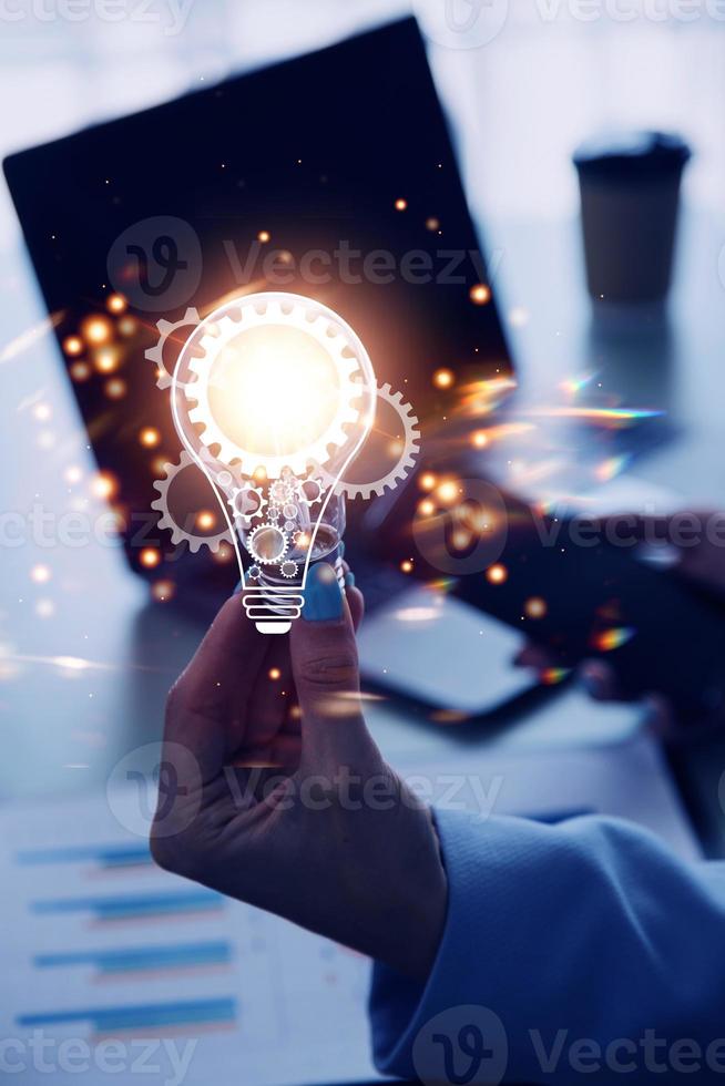 Hand of businessman holding illuminated light bulb with network connection line, idea, innovation and inspiration concept. concept creativity with bulbs that shine glitter. photo