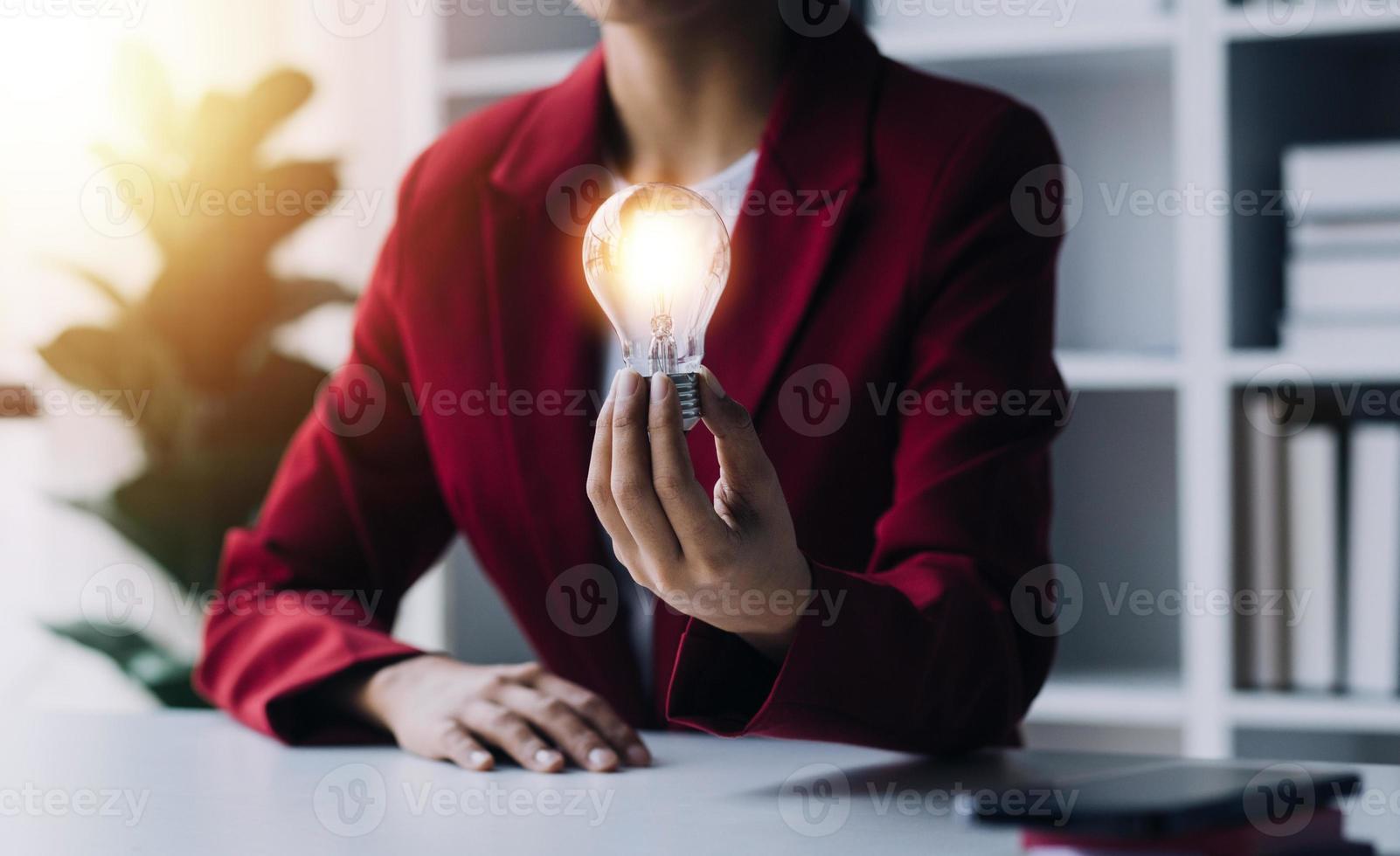 Business People touch Light bulb.Concept of Ideas for Success. Concept with Innovation Invention. Success Starting from a new idea to innovative technology based on data from the Internet, big data. photo