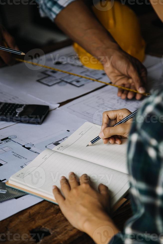 Construction and structure concept of engineer working drawing on blueprint meeting for project working with partner on model building and engineering tools in working site, construction concept photo