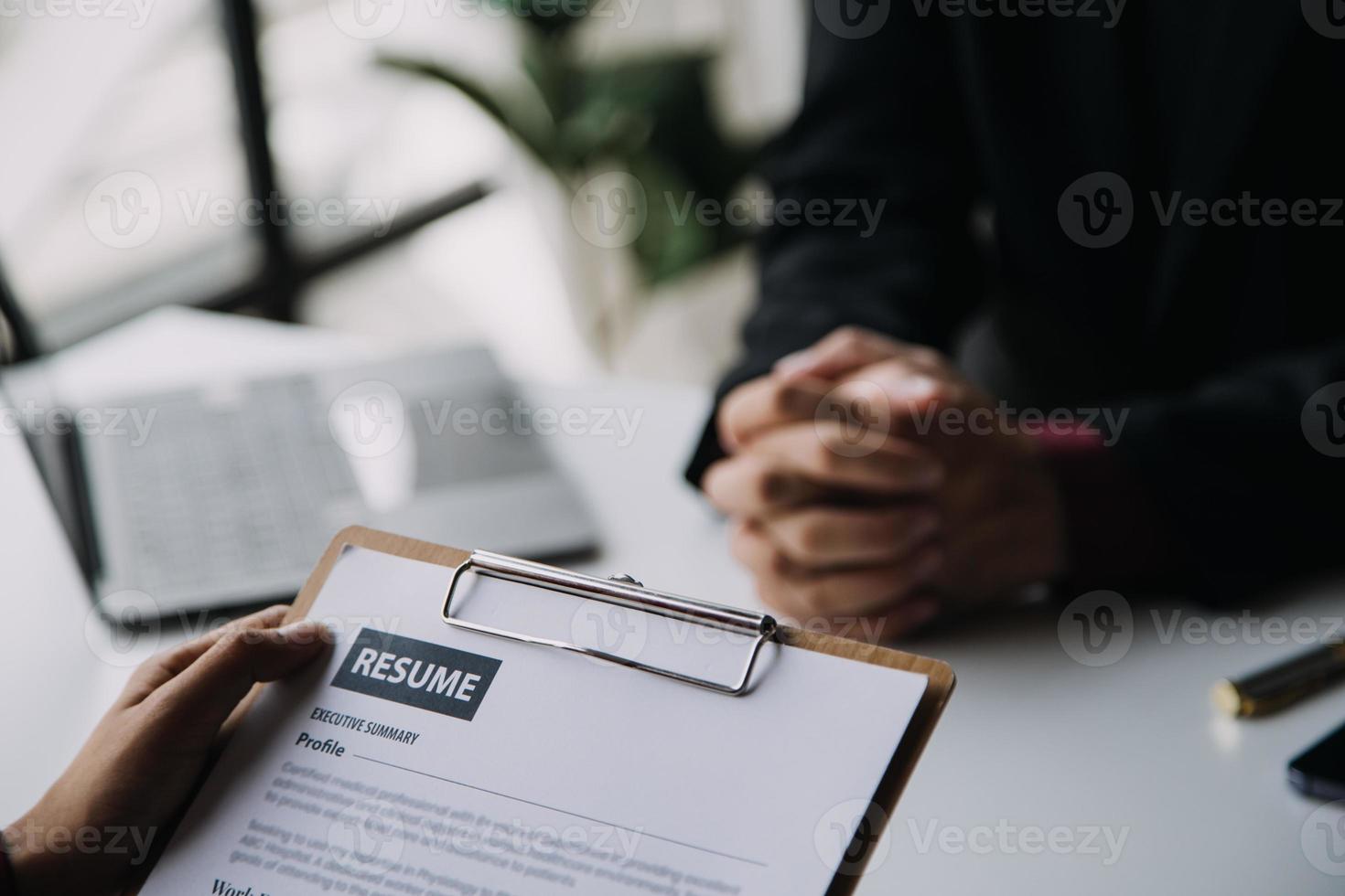 Close up view of job interview in office, focus on resume writing tips, employer reviewing good cv of prepared skilled applicant, recruiter considering application, hr manager making hiring decision photo