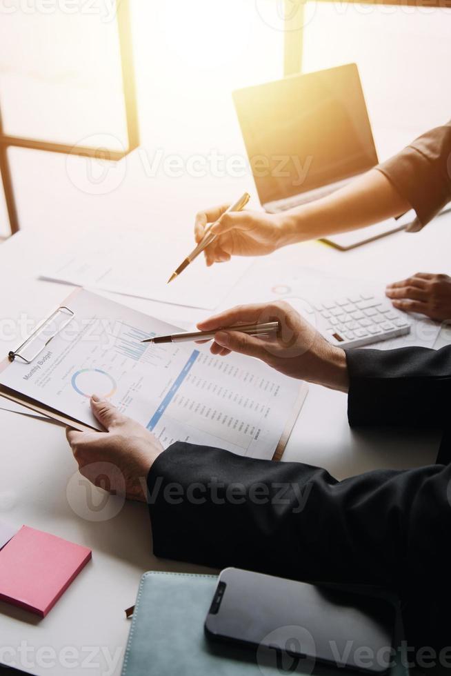 Financial analysts analyze business financial reports on a digital tablet planning investment project during a discussion at a meeting of corporate showing the results of their successful teamwork. photo