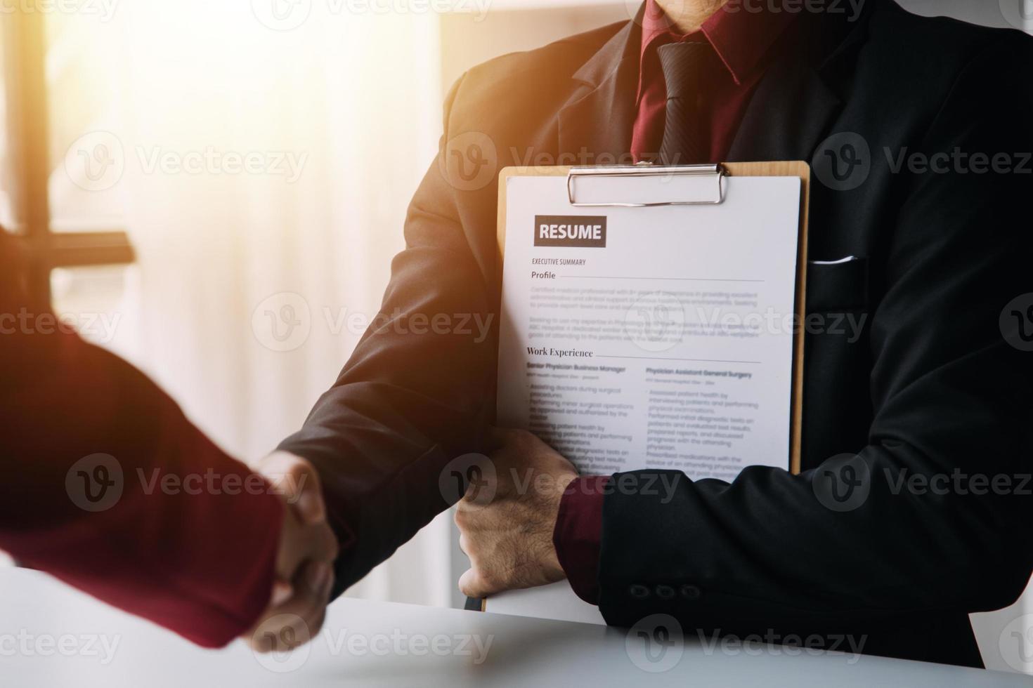 Close up view of job interview in office, focus on resume writing tips, employer reviewing good cv of prepared skilled applicant, recruiter considering application, hr manager making hiring decision photo