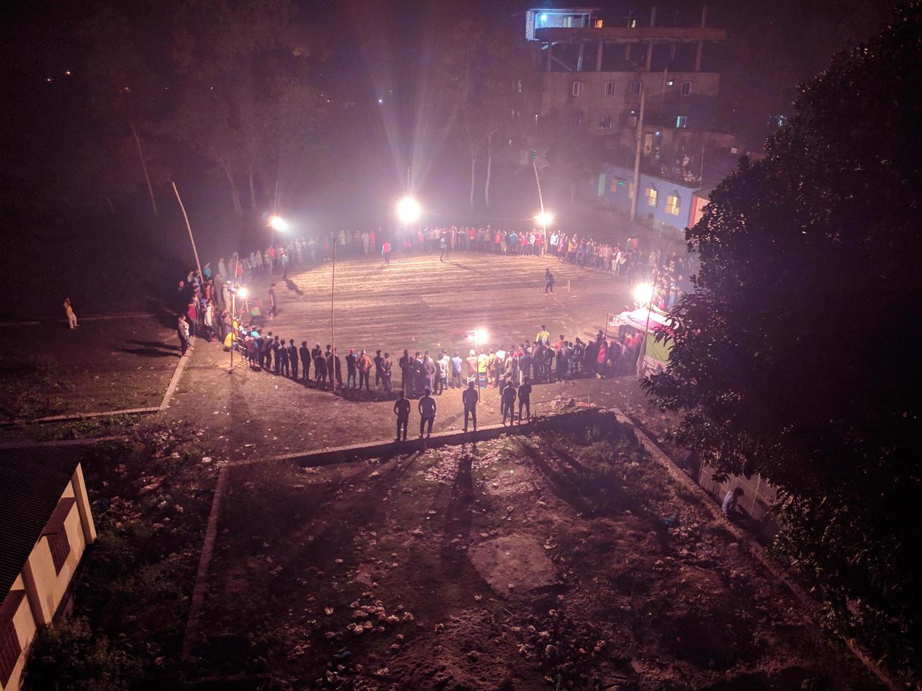 Rangpur, Bangladesh 2023. Local Stadium for cricket match.People around the playground in Night of top view.There are crowds around the middle of the night to watch the game.Top view Arial photo