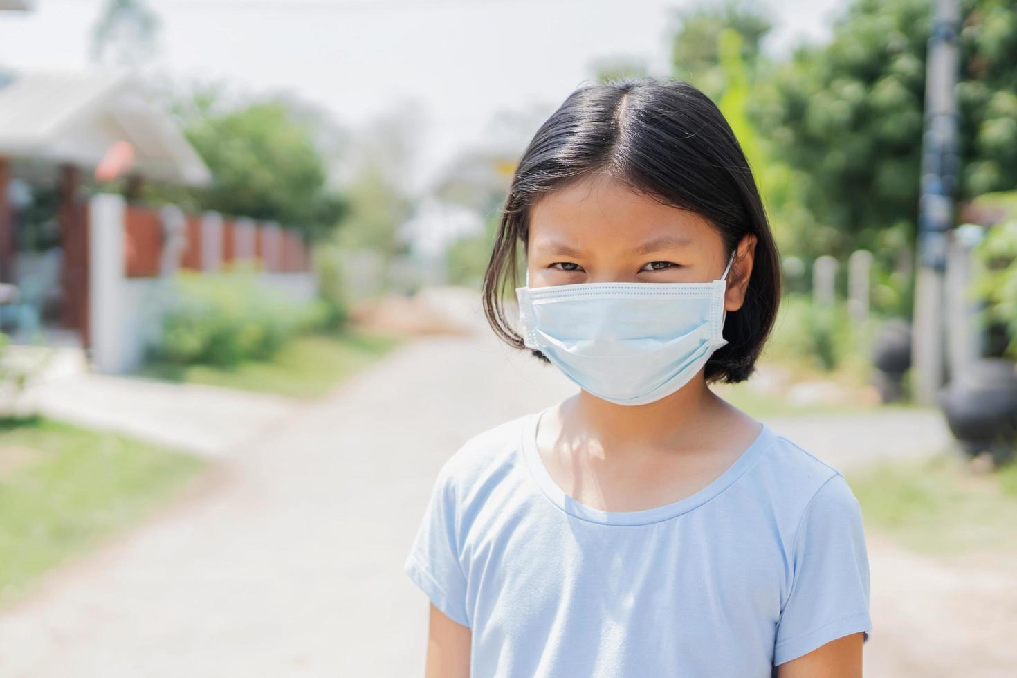 children girl wearing face mask protect of air pollution and virus epidemic of  covid 19 photo