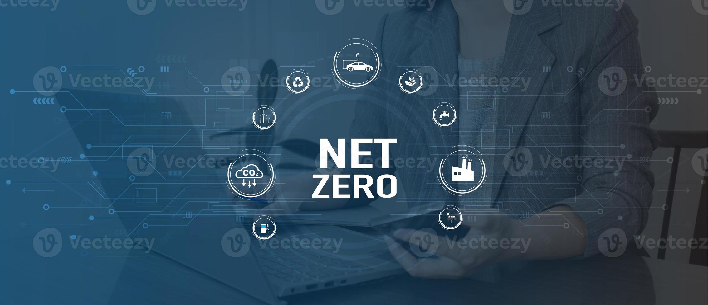 Net Zero Eco business concept. Women use a computer to analyze Net Zero, surrounded by Net Zero icons .close to the computer screen in business investment strategy concept. photo
