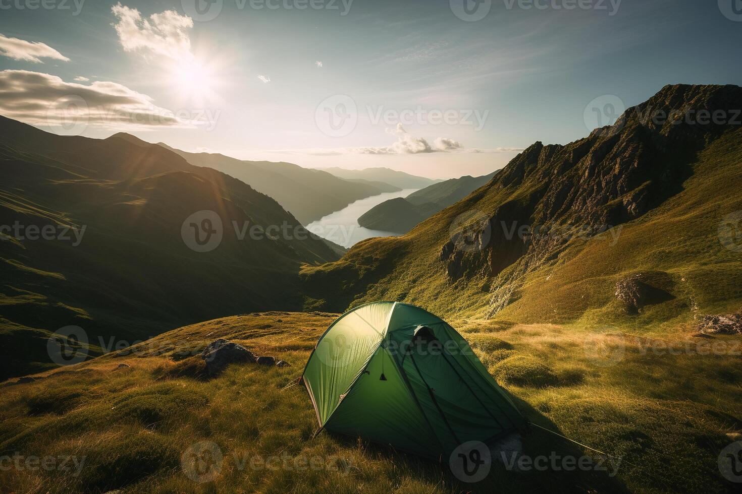 A tourist tent pitched on top of a mountain at sunrise. Tourism and physical activity concept. photo