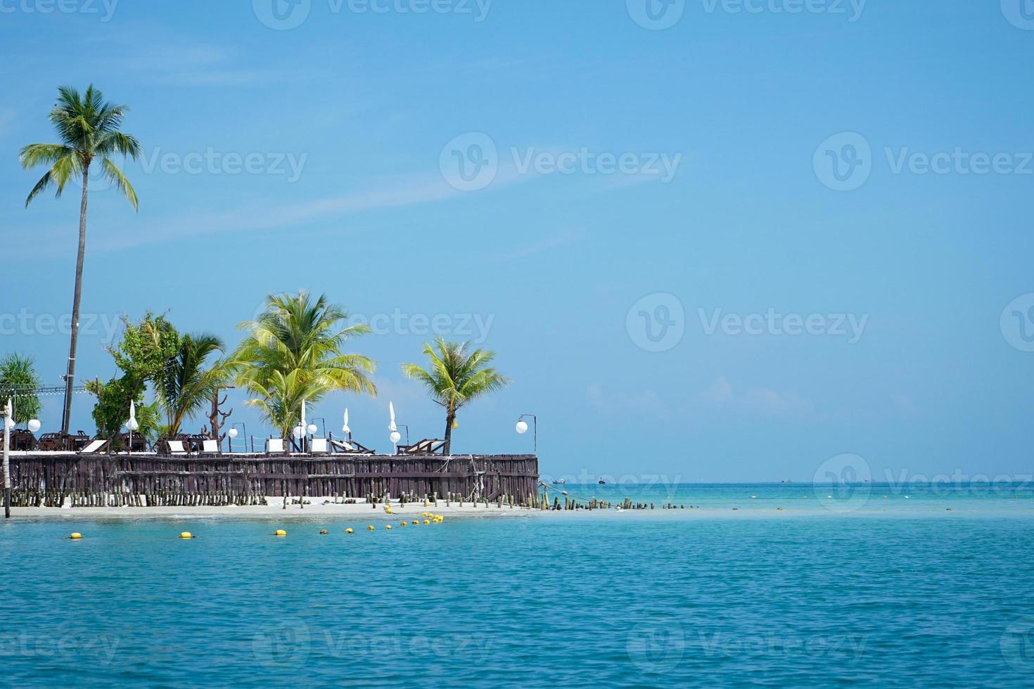 Landscape of the resort at the cape of the coast with coconut trees and beach bench. Horizontal line of seascape with attractive destination photo