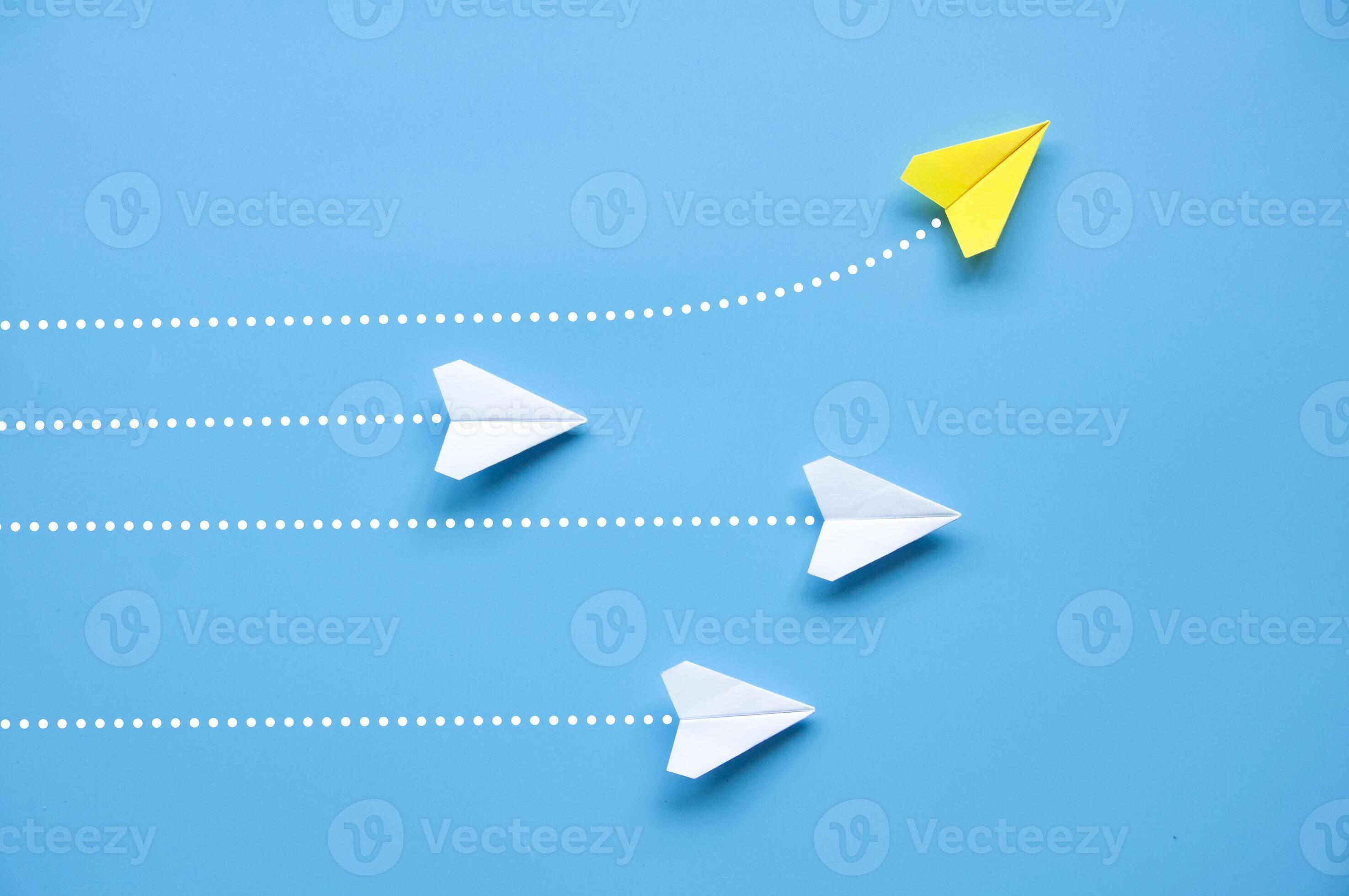 Top view of paper airplane Yellow paper airplane origami flying to a different direction