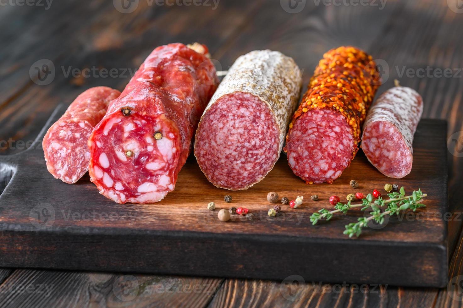 Assortment of salami on the wooden board photo