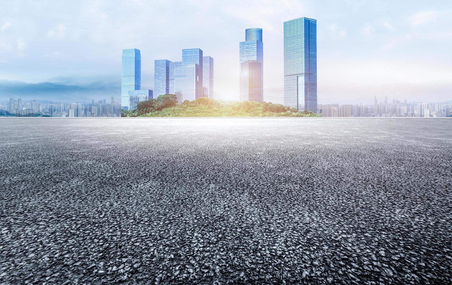 Asphalt road and modern city skyline with buildings.Unmanned asphalt pavement and modern urban skyline. photo