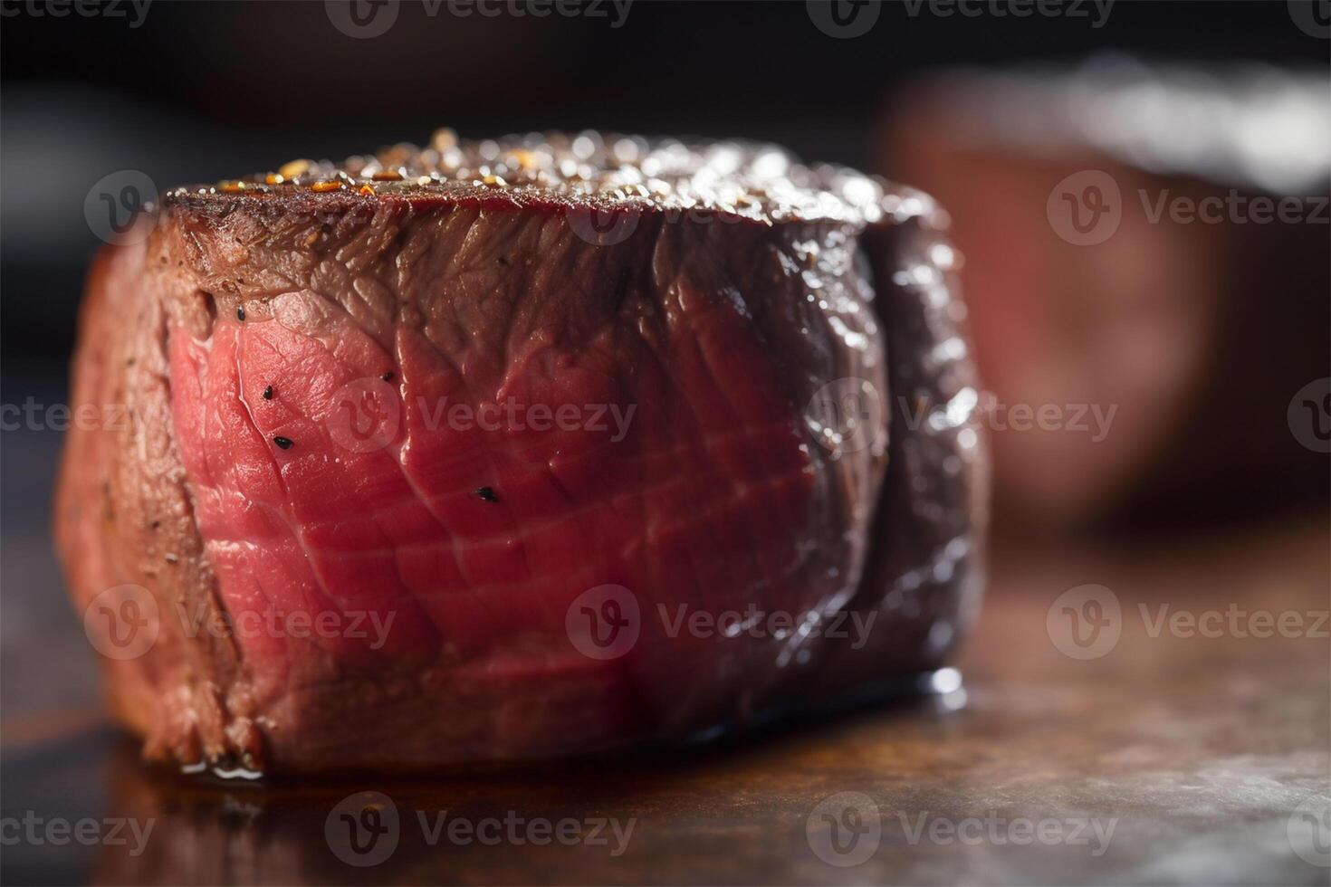 Raw Organic Beef Filet Mignon over a wooden counter on dark background. photo