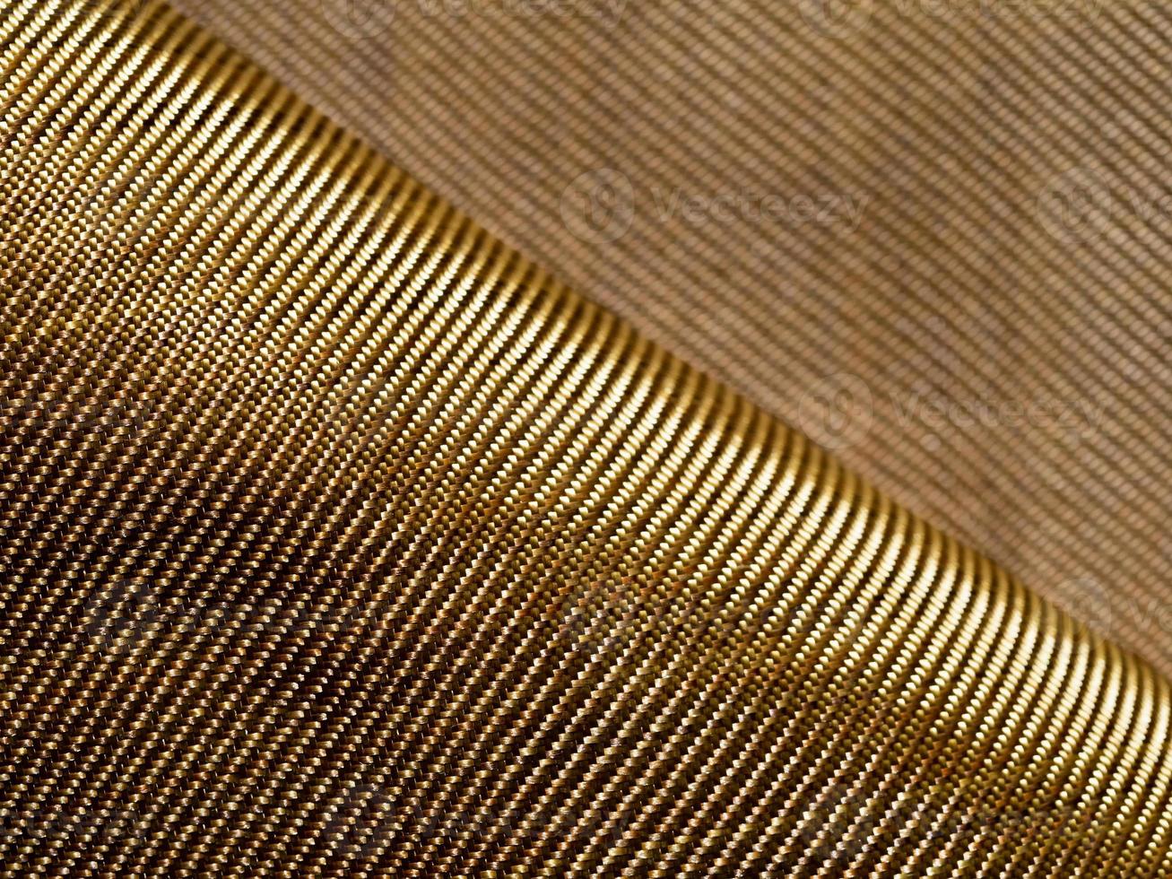 The bend of the golden fabric bulletproof material aramid. Aramid
