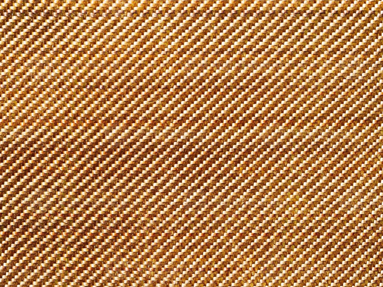 Bulletproof material aramid. Aramid kevlar background. Golden kevlar texture and pattern. photo