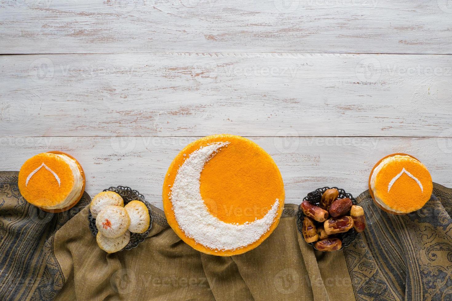 Festive food Ramadan background. Delicious homemade golden cake with a Crescent moon, served with dates. Top view. photo