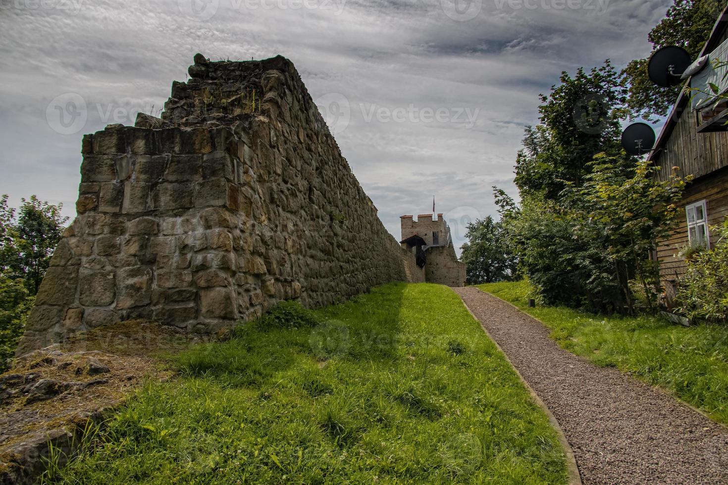historic defensive wall of a stone castle in Poland in Dobczyce on a summer day overlooking the lake photo