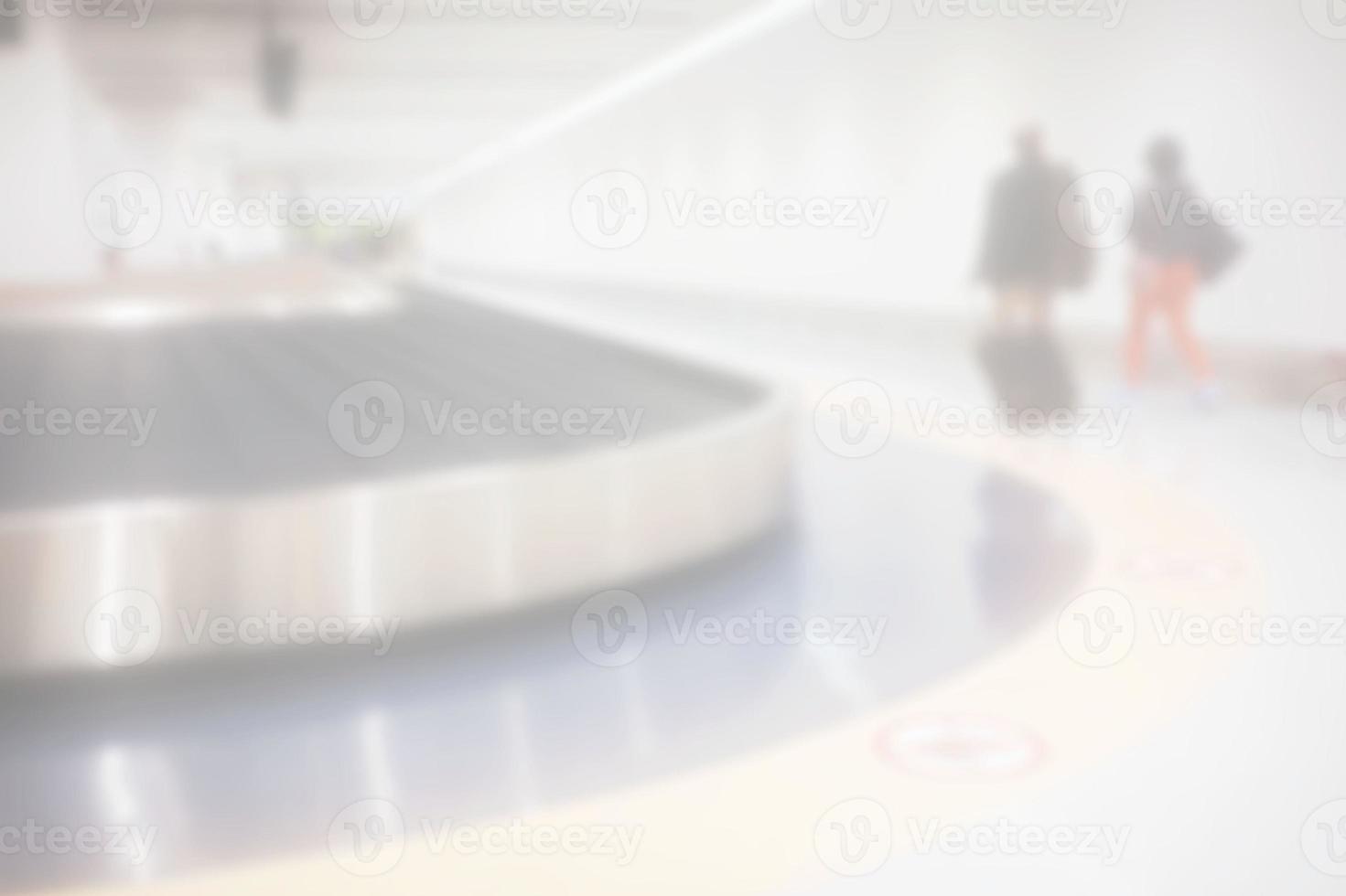 White Blurred Passengers Walking in Luggage Conveyor Belt Zone of the Airport. photo