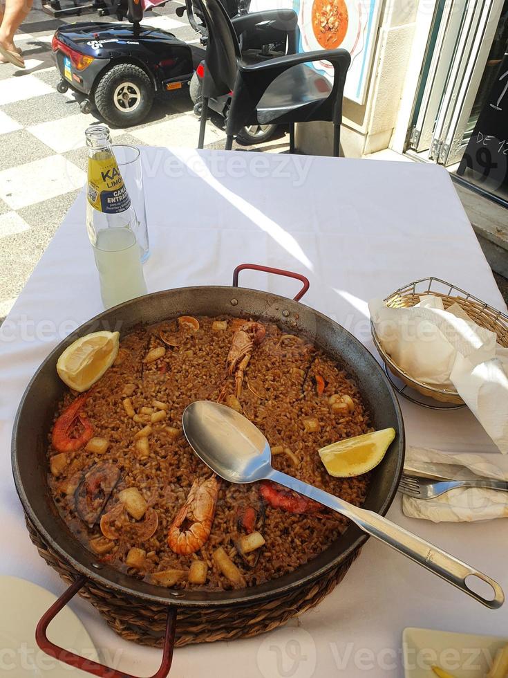 hot Spanish paella with seafood and prawns and a spoon photo