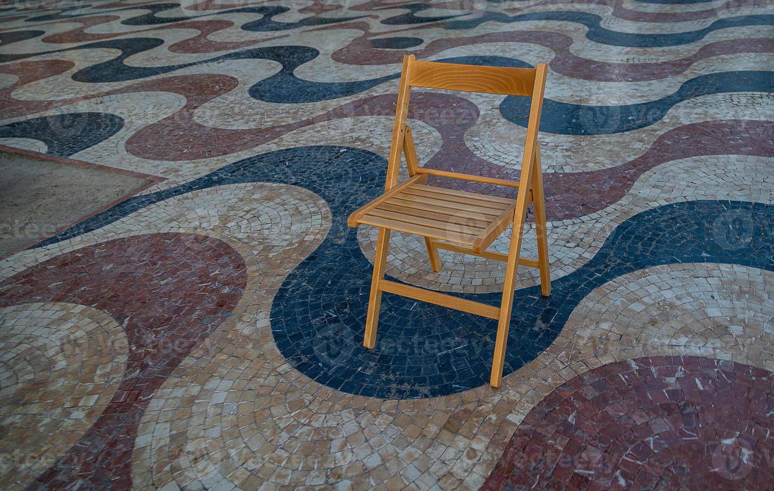 Explanada promenade in Alicante Spain landmark with wooden empty chair on mosaic photo