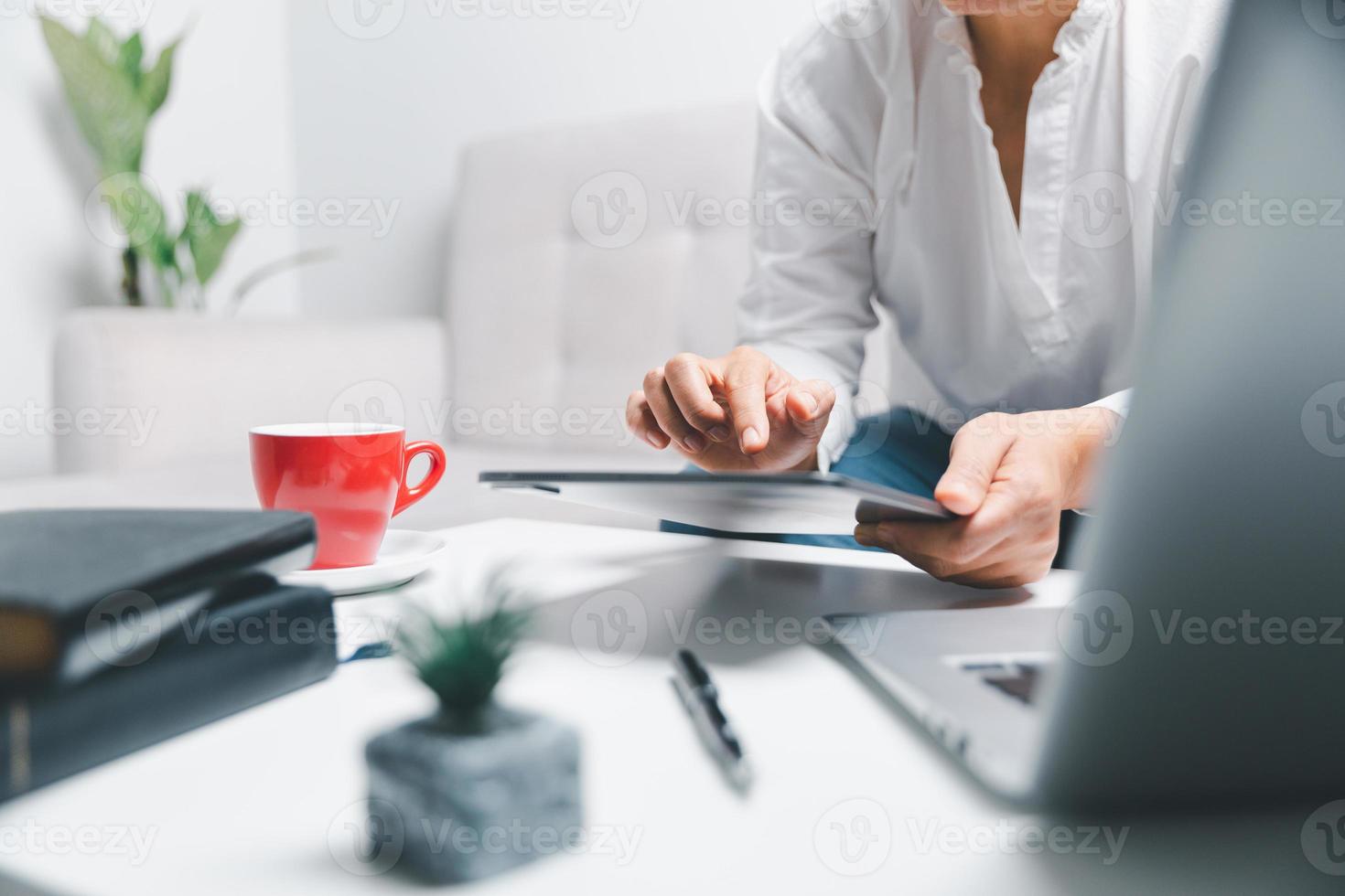 Social media day concept. Female freelancer starting working day early in living room for website with digital tablet. Businesswoman working in home office. Woman communicating with online technology. photo