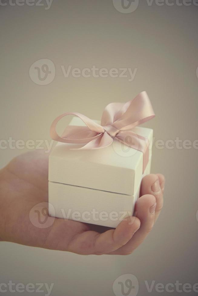 a gift in a white box with a pink bow photo