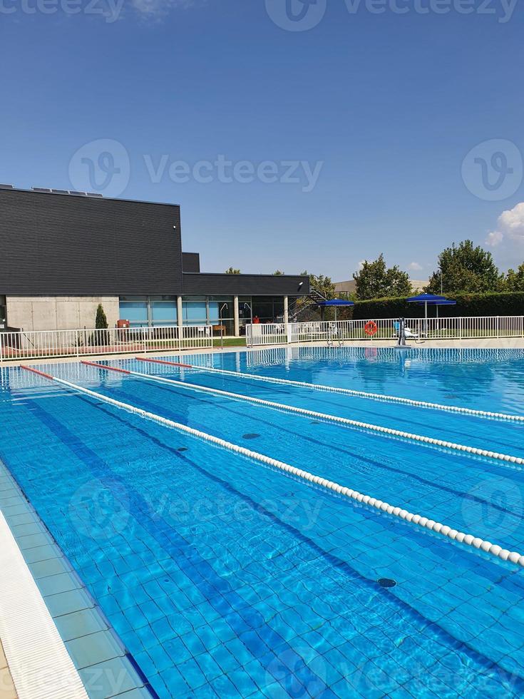 view of empty outdoor pool with swimming lanes on summer sunnyday photo