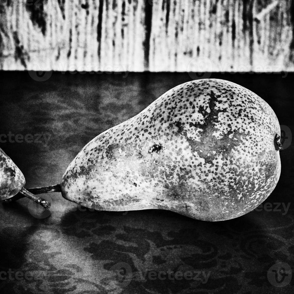 still life with pears on a wooden background photo