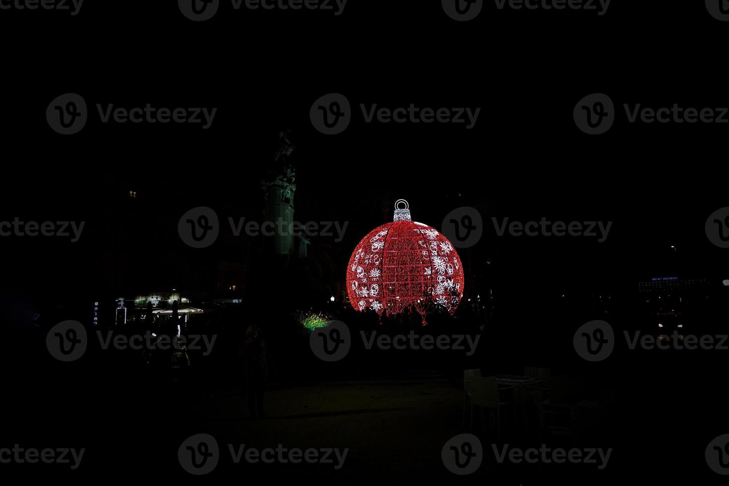 big glowing red bauble Christmas decoration in Alicante, Spain at night photo