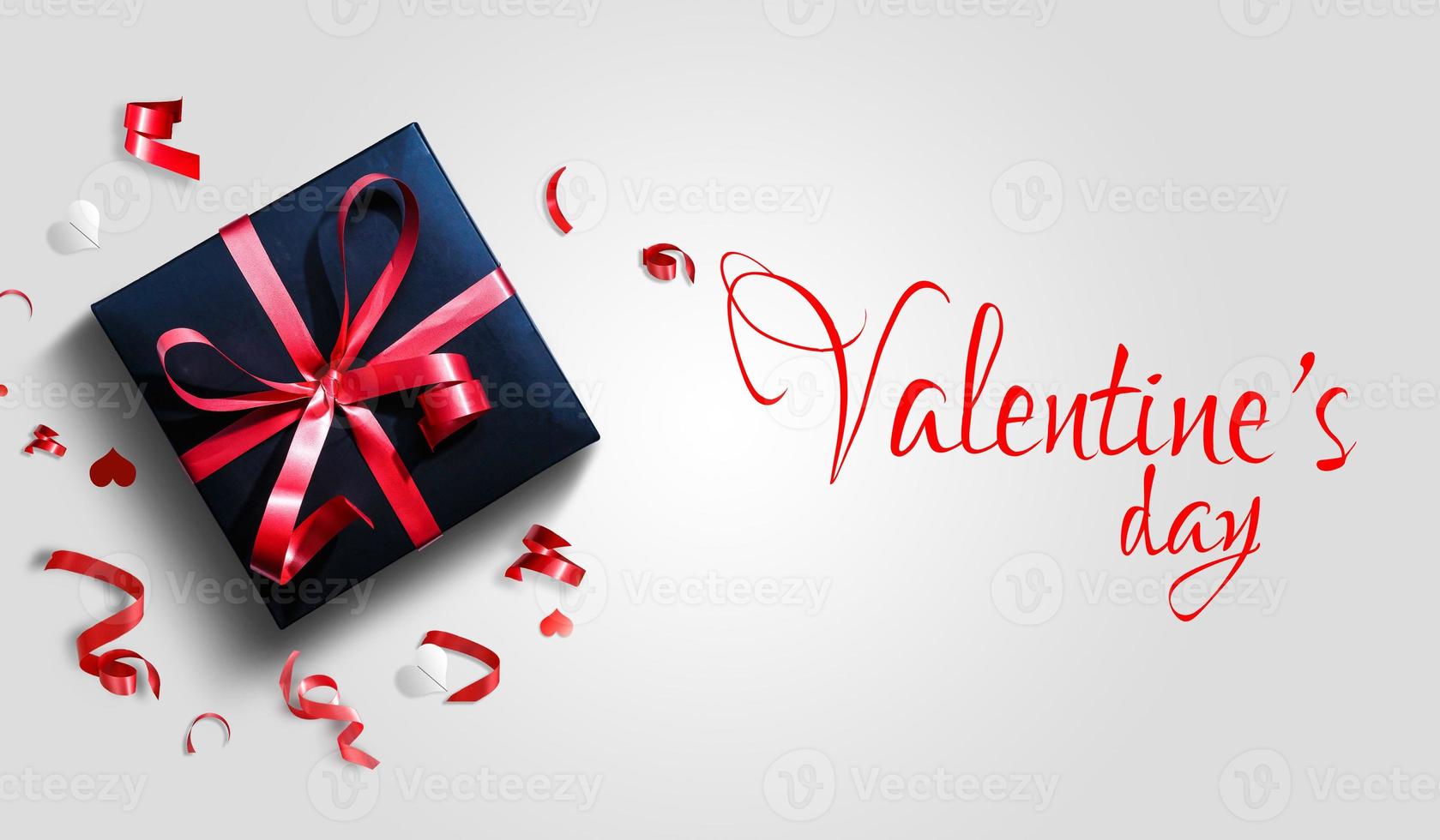 Decorative gift box with red bow and long ribbon. Happy Women's Day. Top view photo