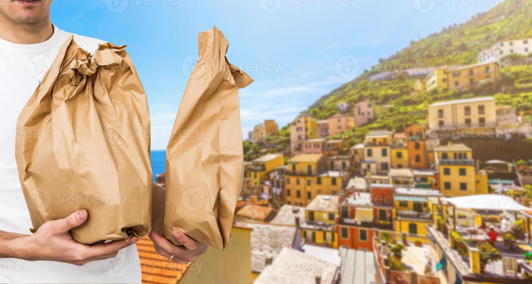 food delivery in paper bags against the background of Italy photo