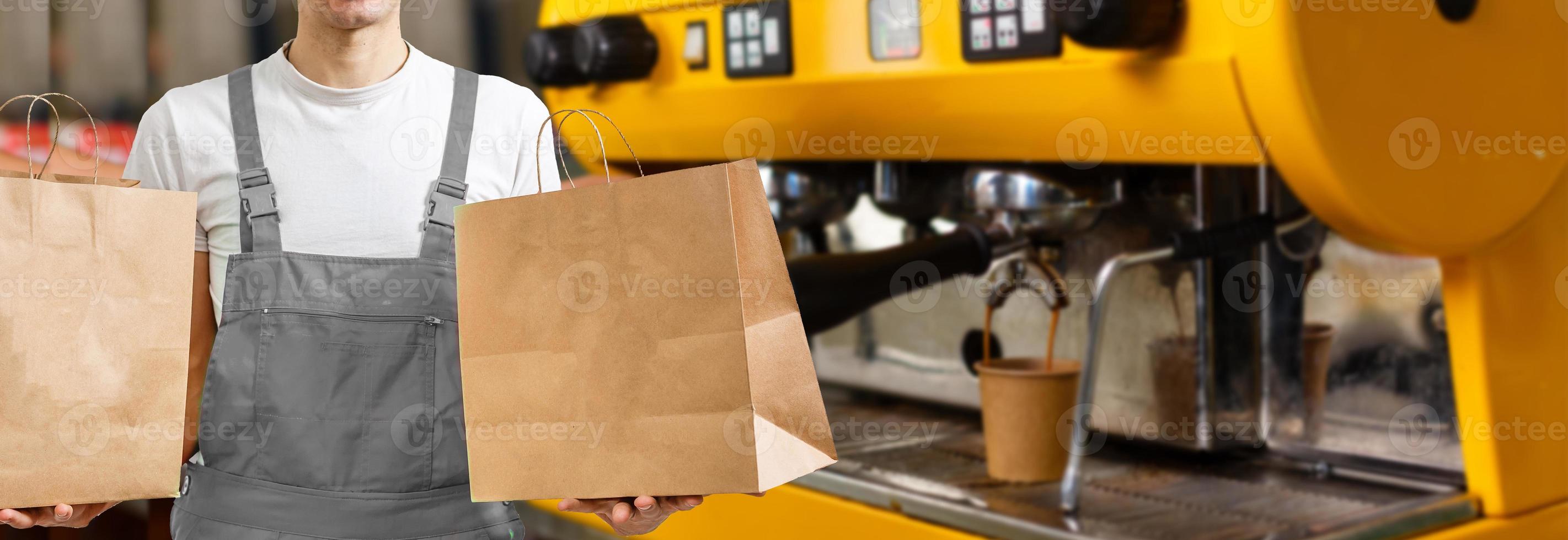 delivery, mail and people concept - happy man delivering food in disposable paper bag to customer home photo