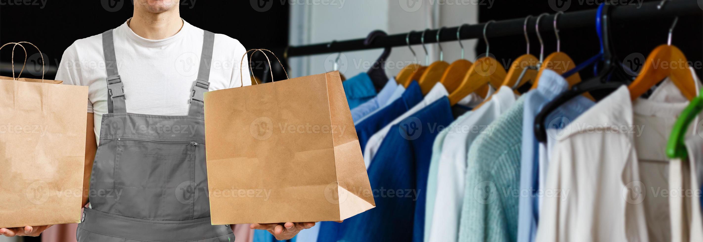 delivery, mail and people concept - happy man delivering food in disposable paper bag to customer home photo