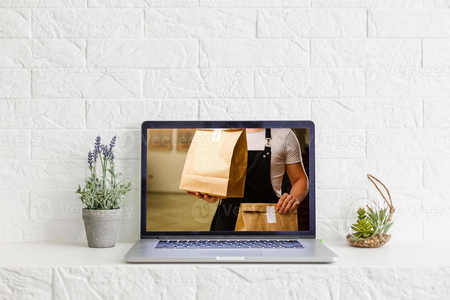 food order concept. Close-up top view of a coolhunter ordering food with a laptop. all screen graphics are made up. photo