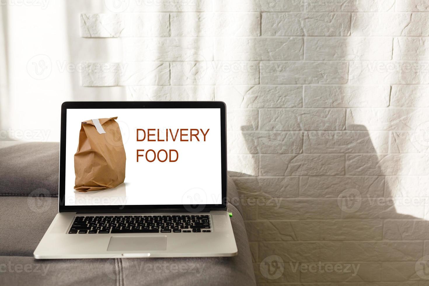 food order concept. Close-up top view of a coolhunter ordering food with a laptop. all screen graphics are made up. photo