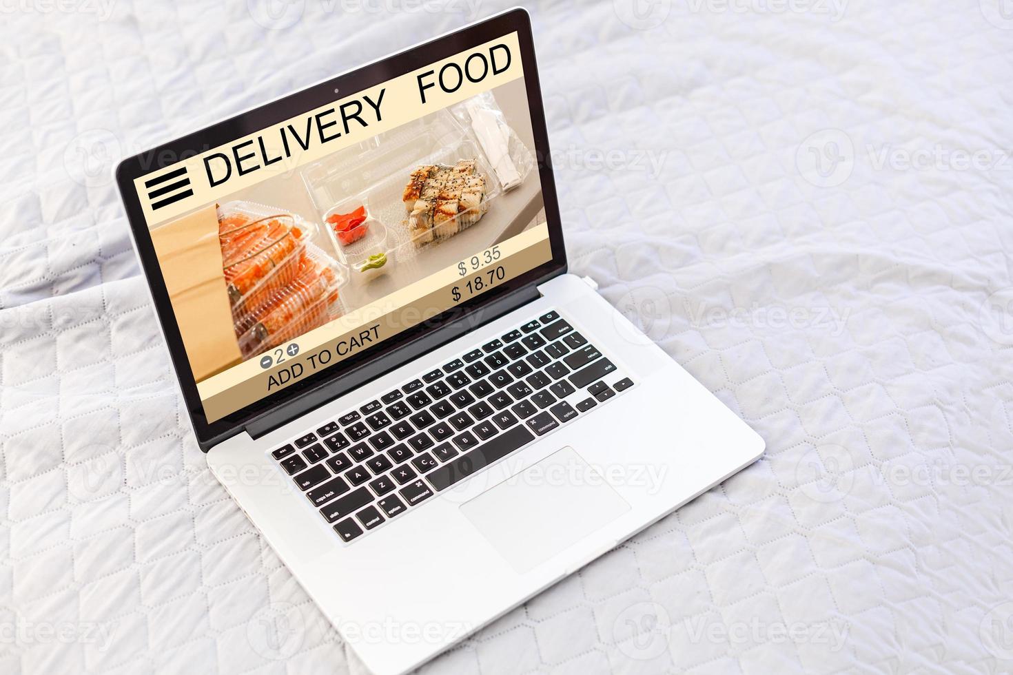 food order concept. Close-up top view of a coolhunter ordering food with a laptop. all screen graphics are made up. photo