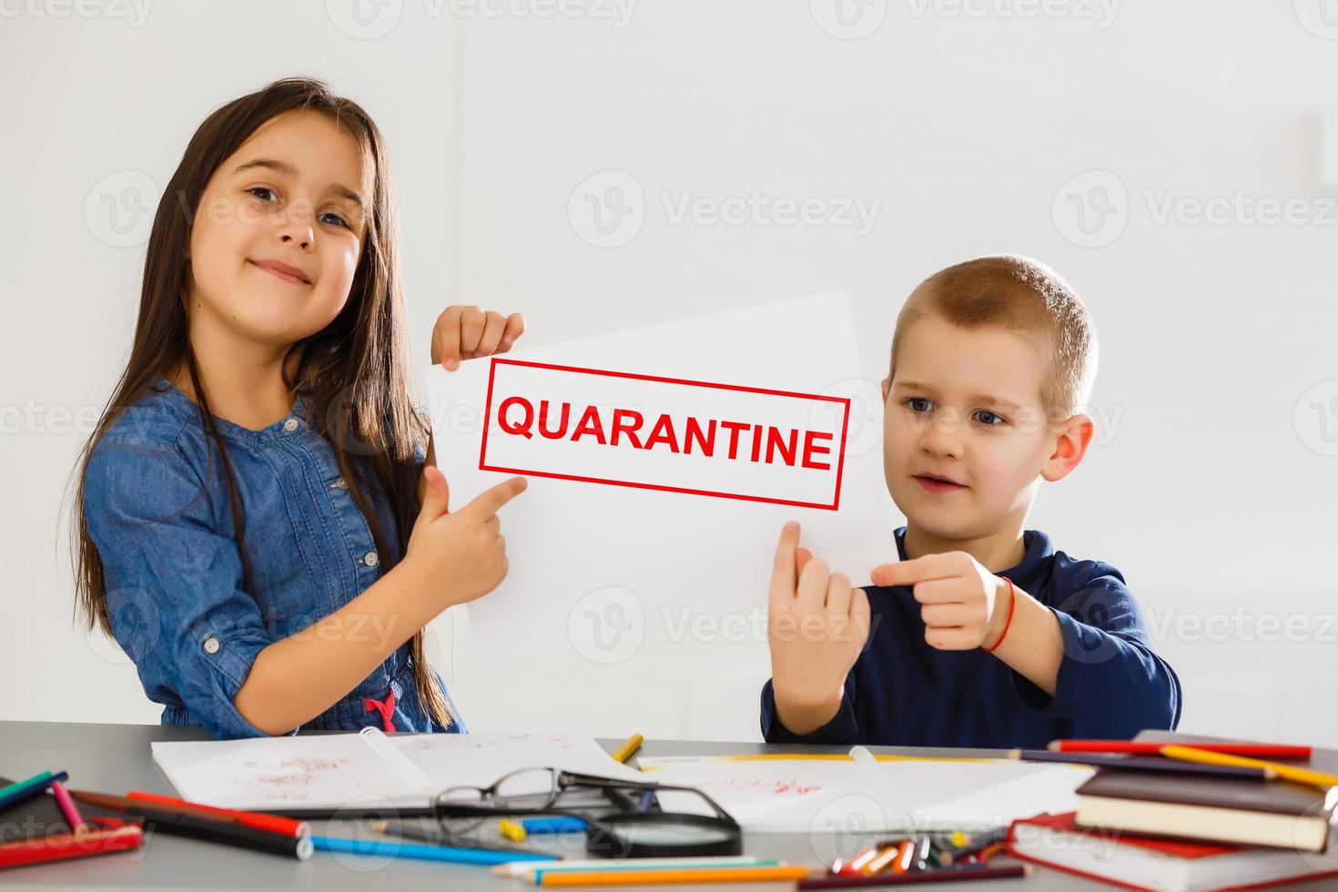 two children are sitting in a room, red inscription quarantine, concept of quarantine measures during the period of the disease epidemic photo