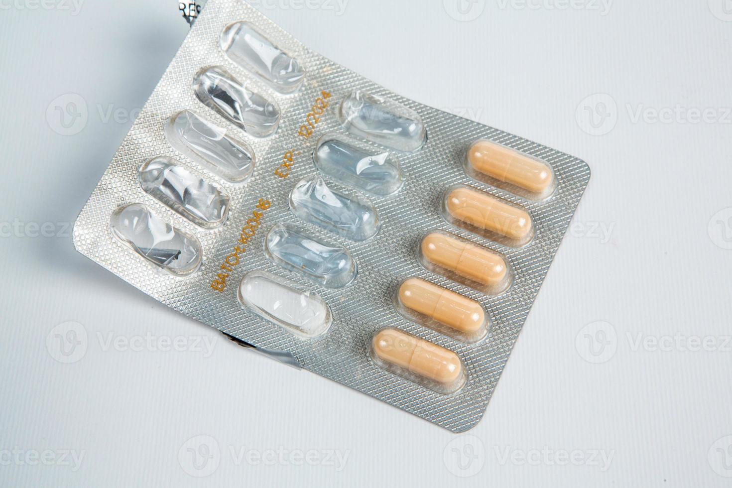 Pills in blister pack on white background. Tablets and capsules in blister packs. Top view, copy space. photo