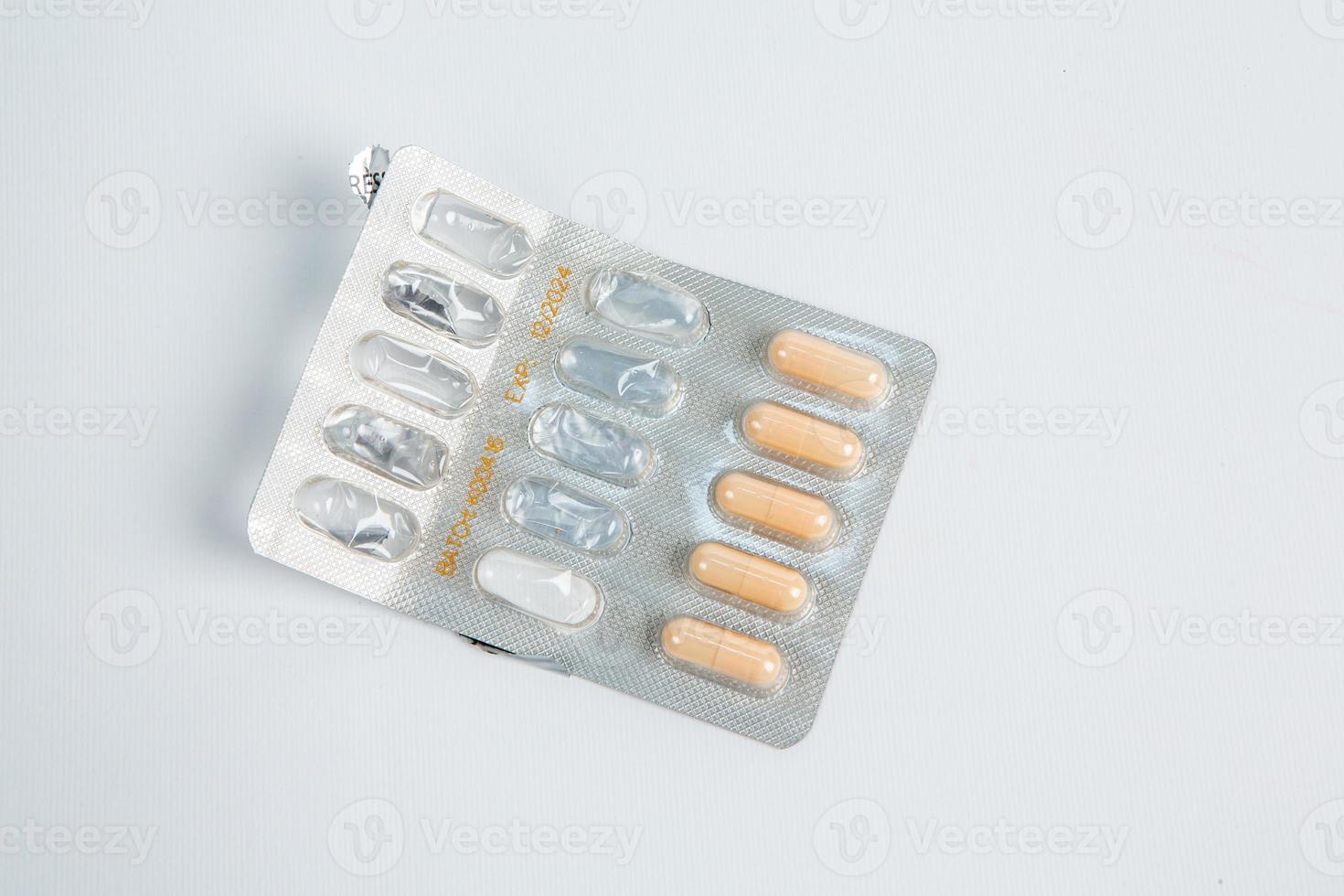 Pills in blister pack on white background. Tablets and capsules in blister packs. Top view, copy space. photo