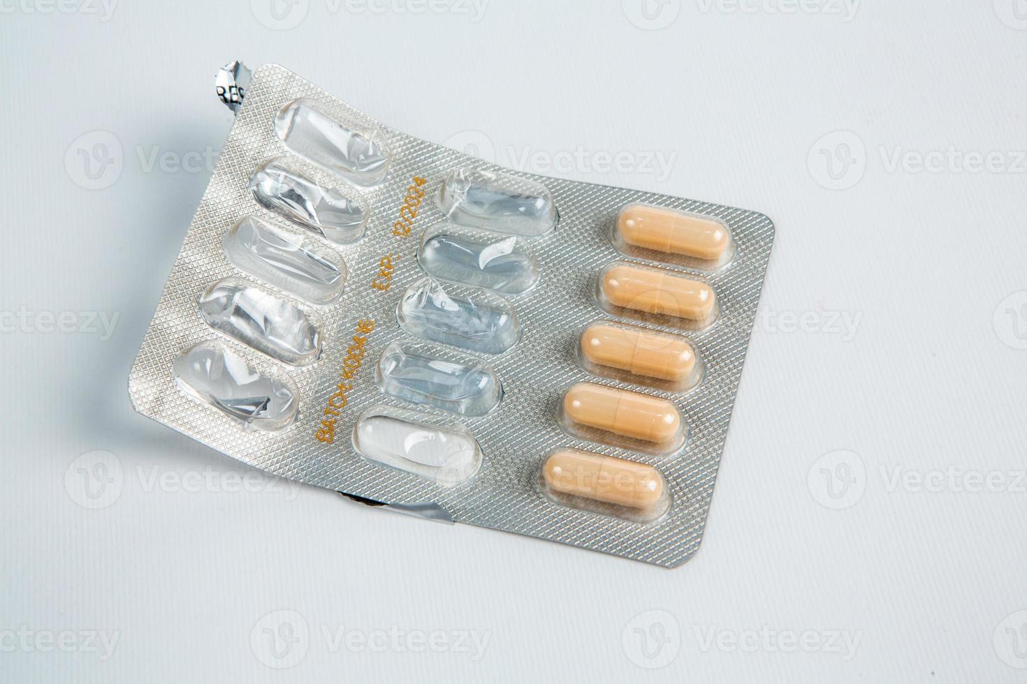 Pills in blister pack on white background. Tablets and capsules in blister packs. Top view, copy space. photo