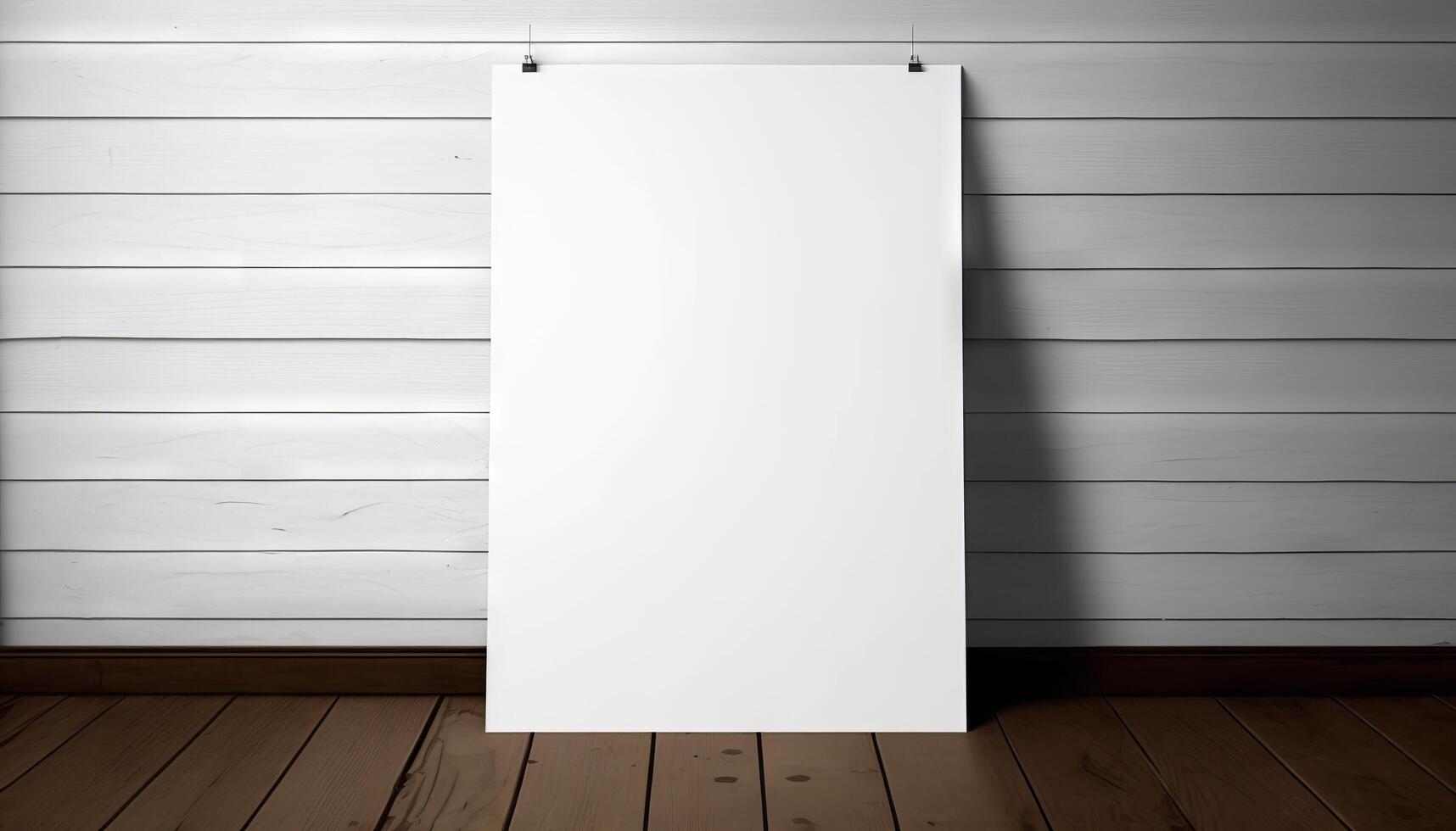 Blank white paper poster on plank wooden floor and wall. photo