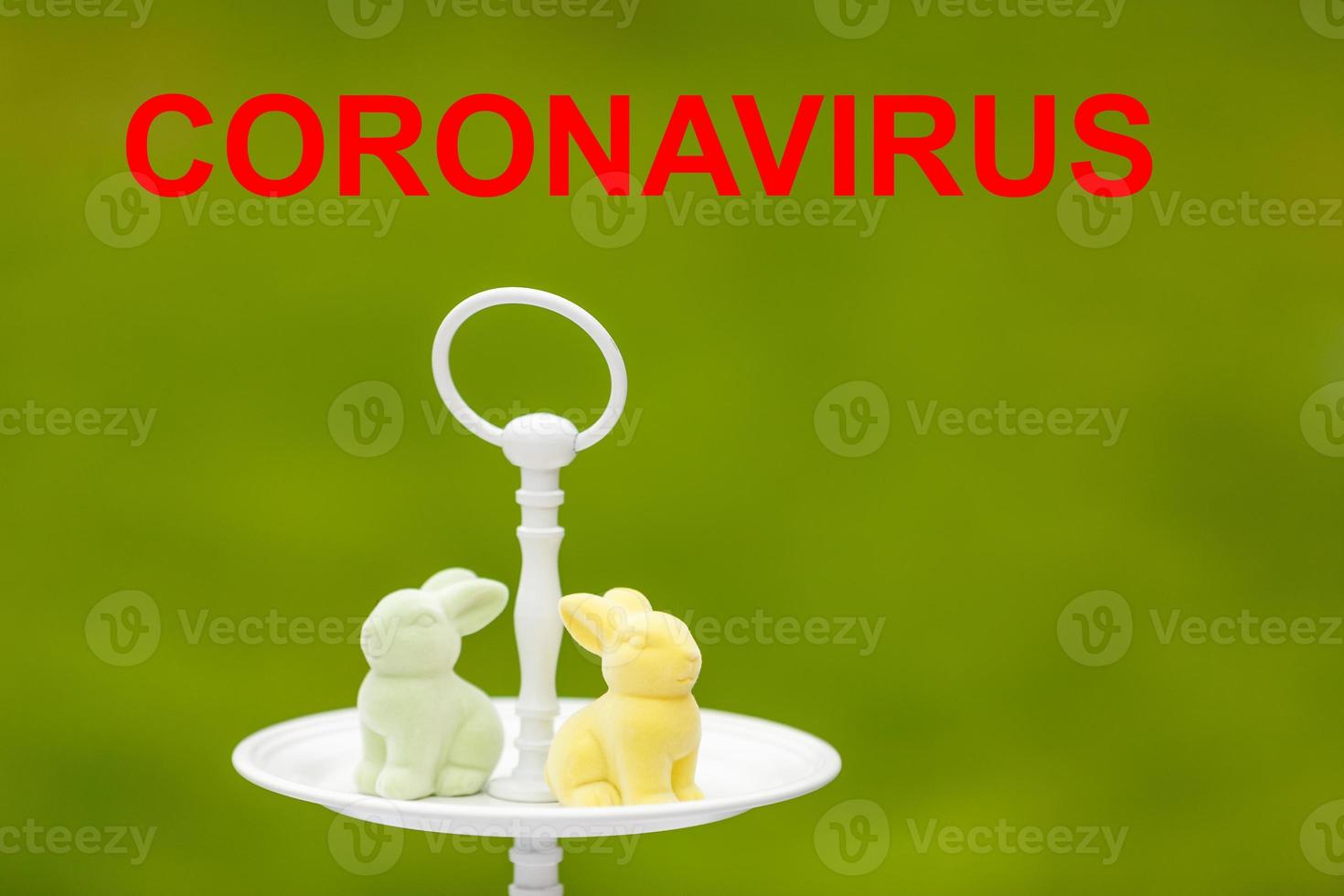 Layout of coronavirus and Easter eggs on the table with a note, close-up. Concept on the possible ban on festive events due to COVID-19 photo