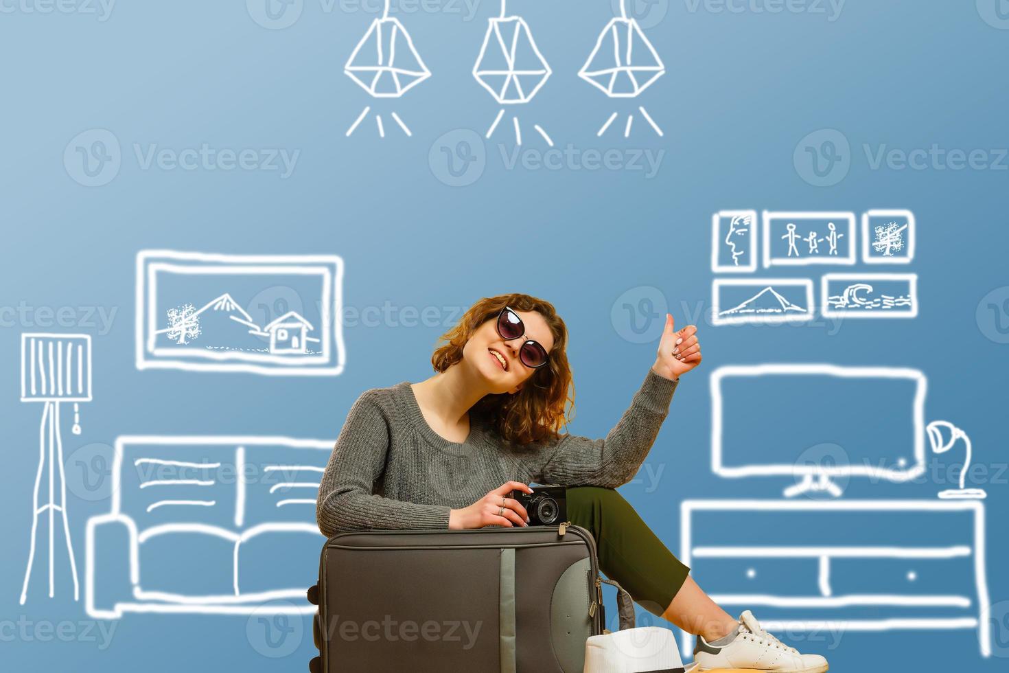Dreaming about new apartment. Cheerful young woman smiling while