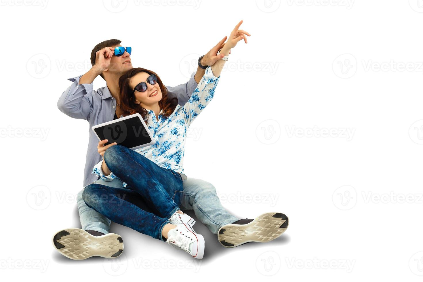 young happy couple using digital tablet, isolated on white photo