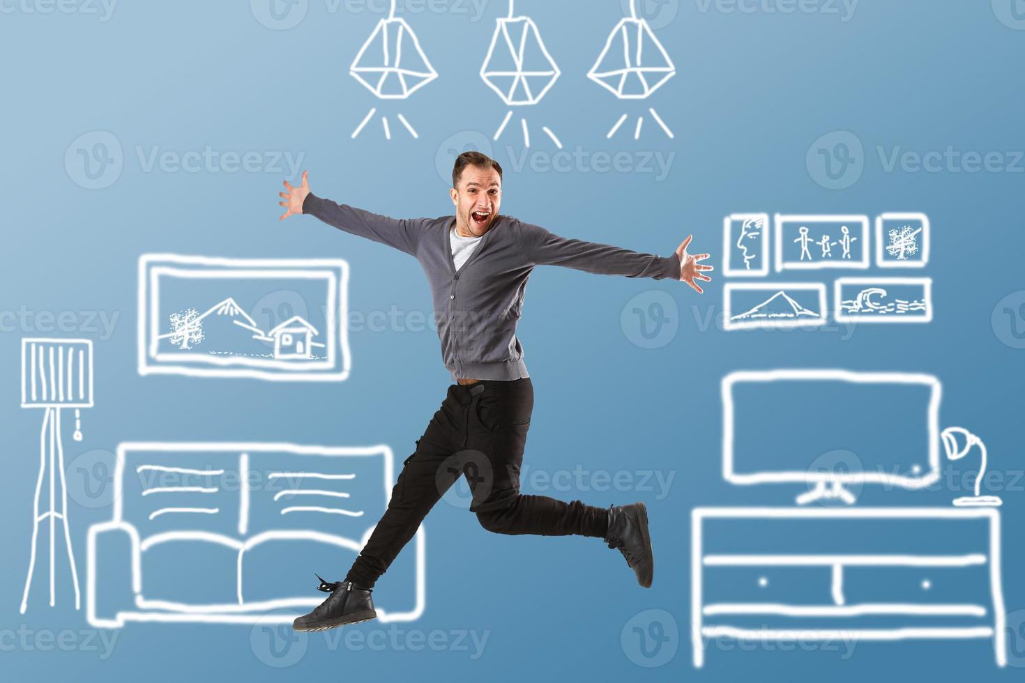 Attractive young boy jumping at huge drawn house photo