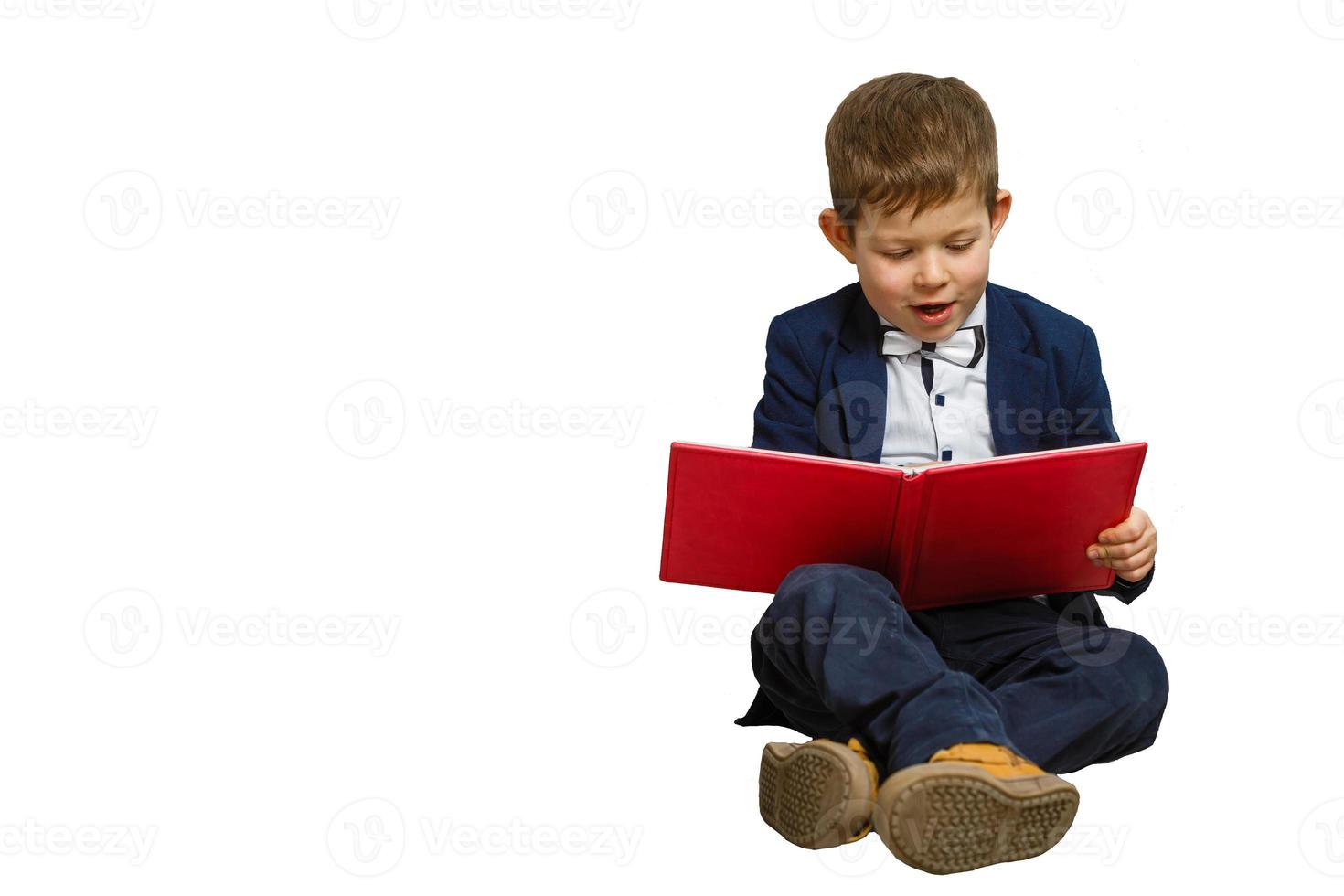 Happy little boy with books isolated on white background photo