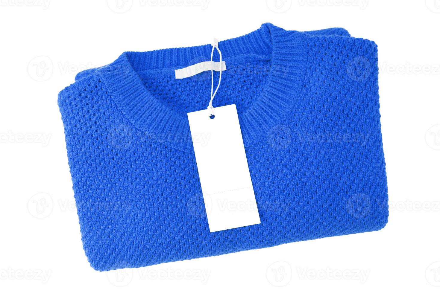 White blank rectangular clothing tag on blue knitted sweater isolated on white background photo