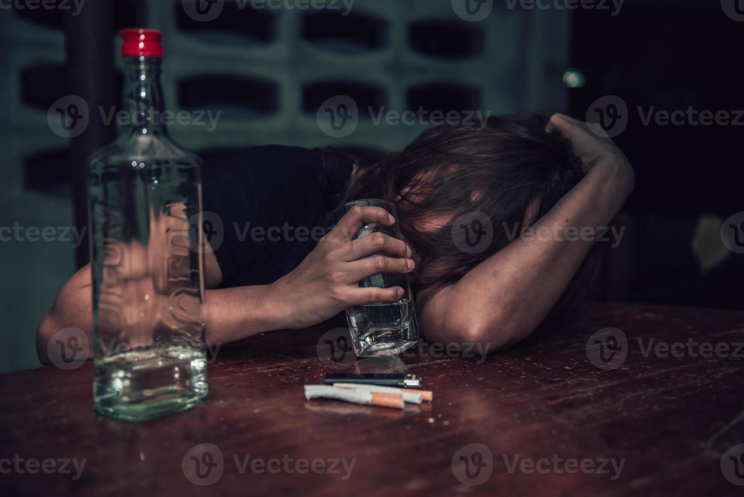 Asian woman drink vodka alone at home on night time,Thailand people,Stress woman drunk concept photo